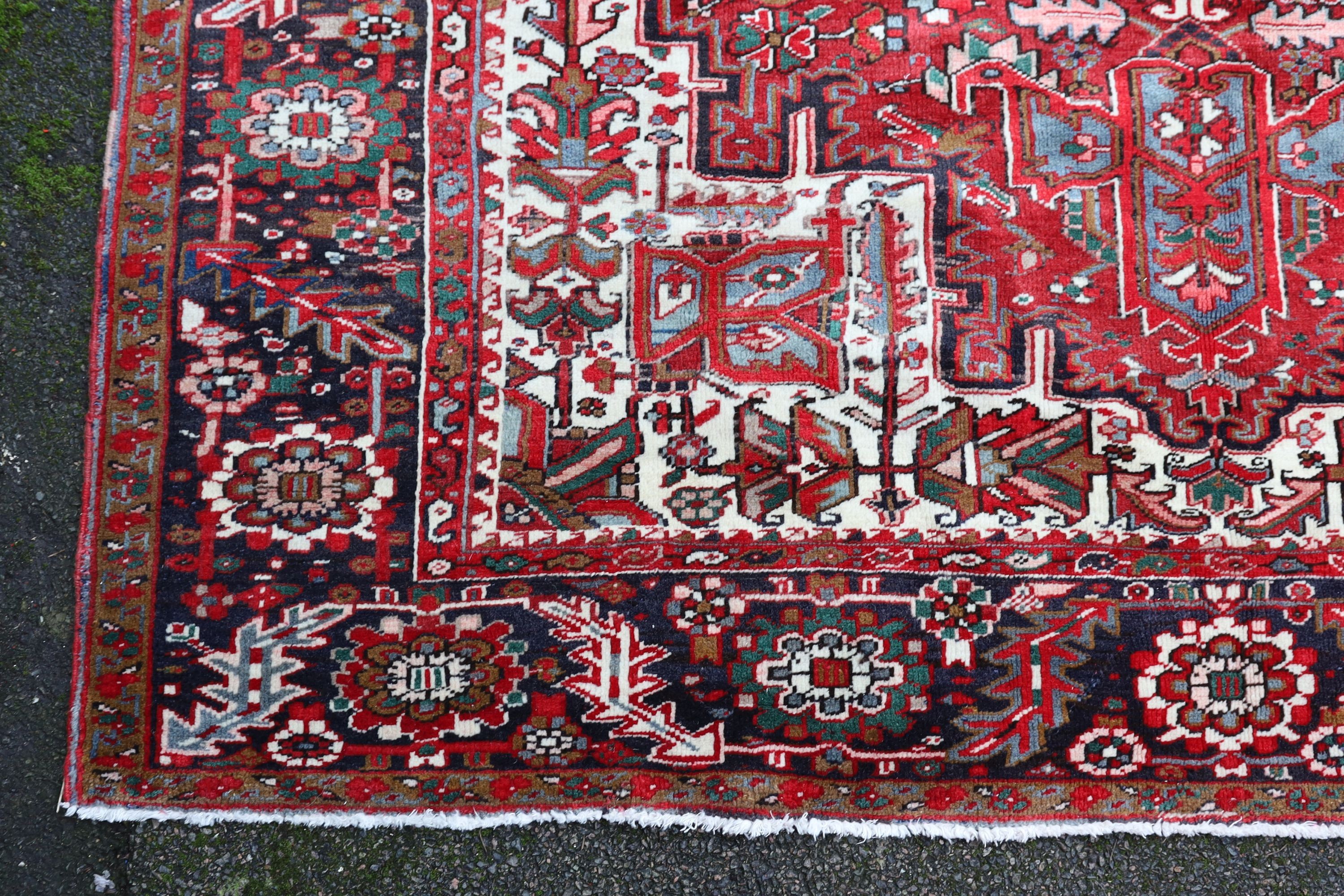 A Heriz red ground carpet, 324 x 243cm.